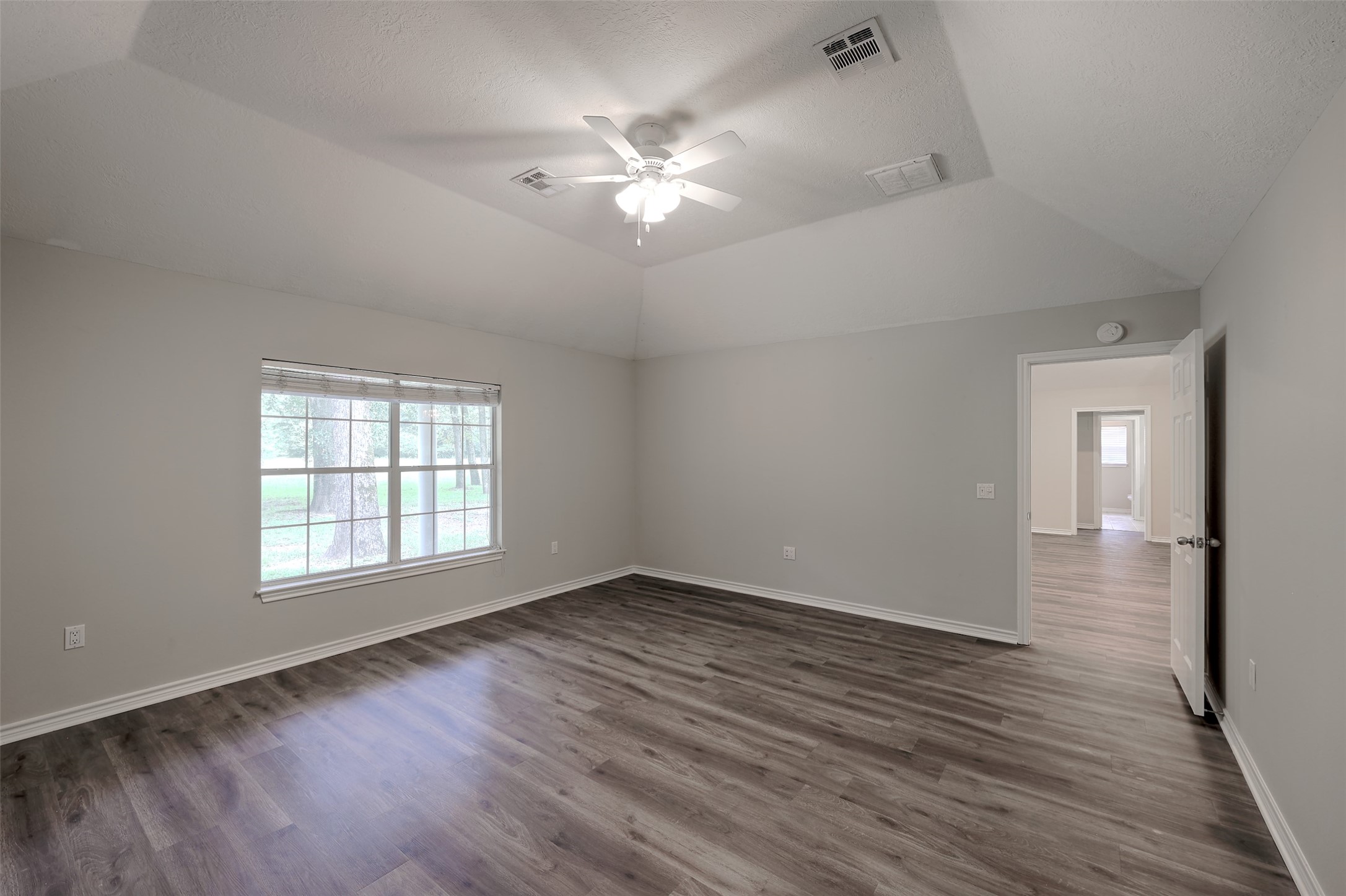 3131 Sapp Road Conroe, TX 77304 - Photo 18 of 48 a view of an empty room with wooden floor and a window