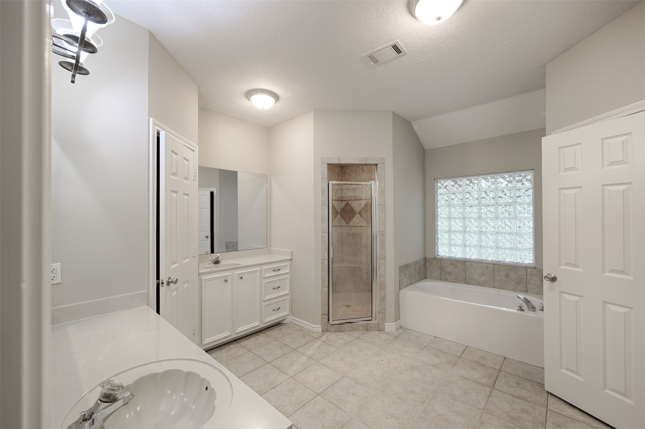 3131 Sapp Road Conroe, TX 77304 - Photo 20 of 48 a spacious bathroom with a tub shower and mirror