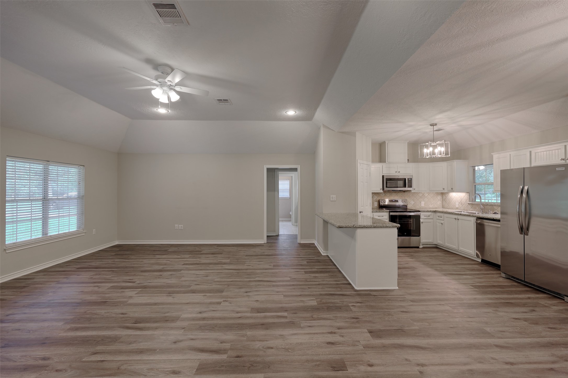 3131 Sapp Road Conroe, TX 77304 - Photo 22 of 48 a view of a kitchen with stove and wooden floor