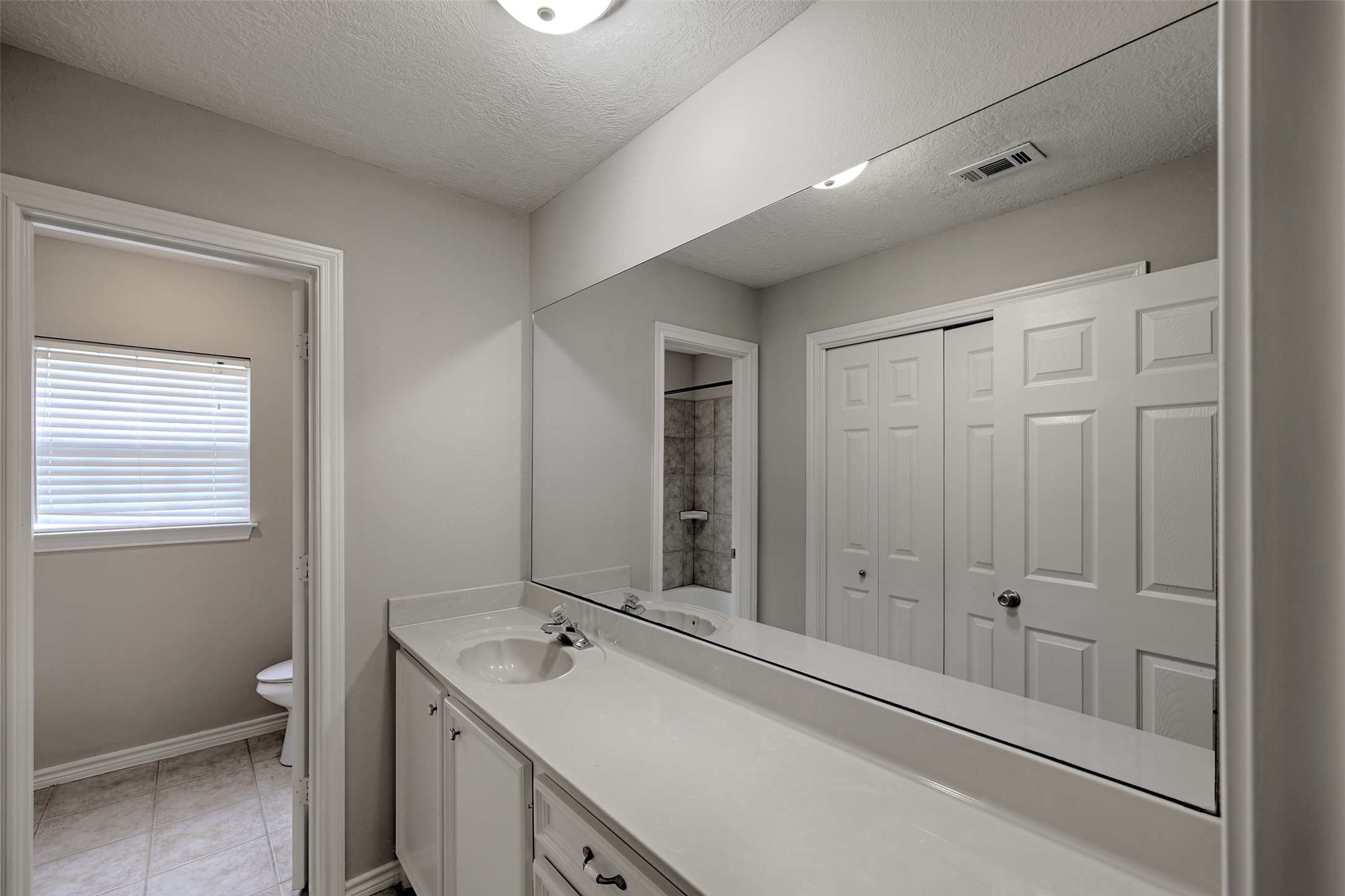 3131 Sapp Road Conroe, TX 77304 - Photo 24 of 48 a bathroom with a sink and a mirror