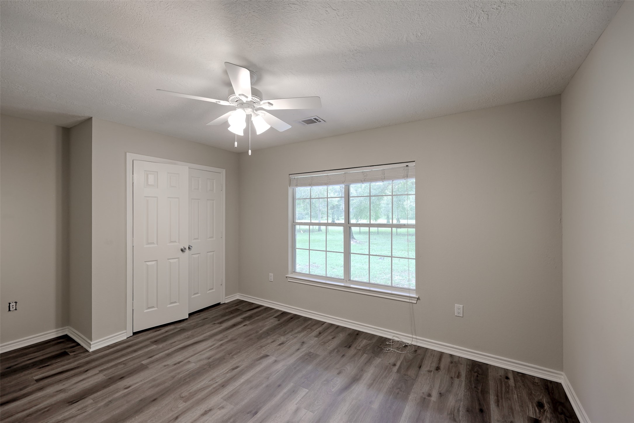 3131 Sapp Road Conroe, TX 77304 - Photo 27 of 48 wooden floor in an empty room with a window