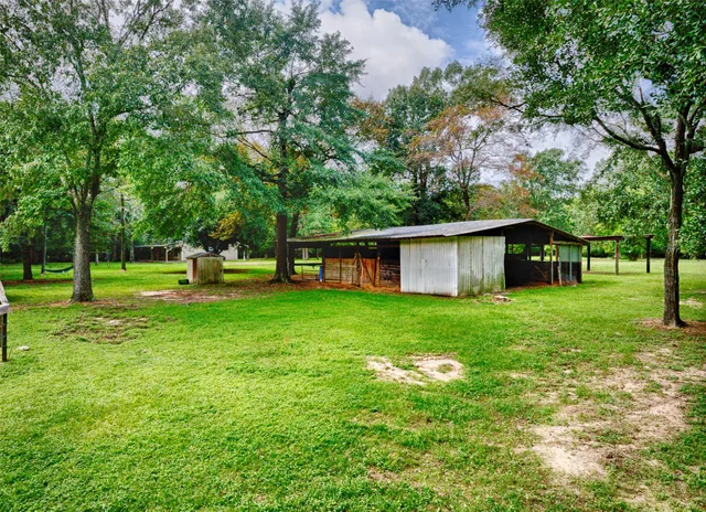 a view of field with trees in the background