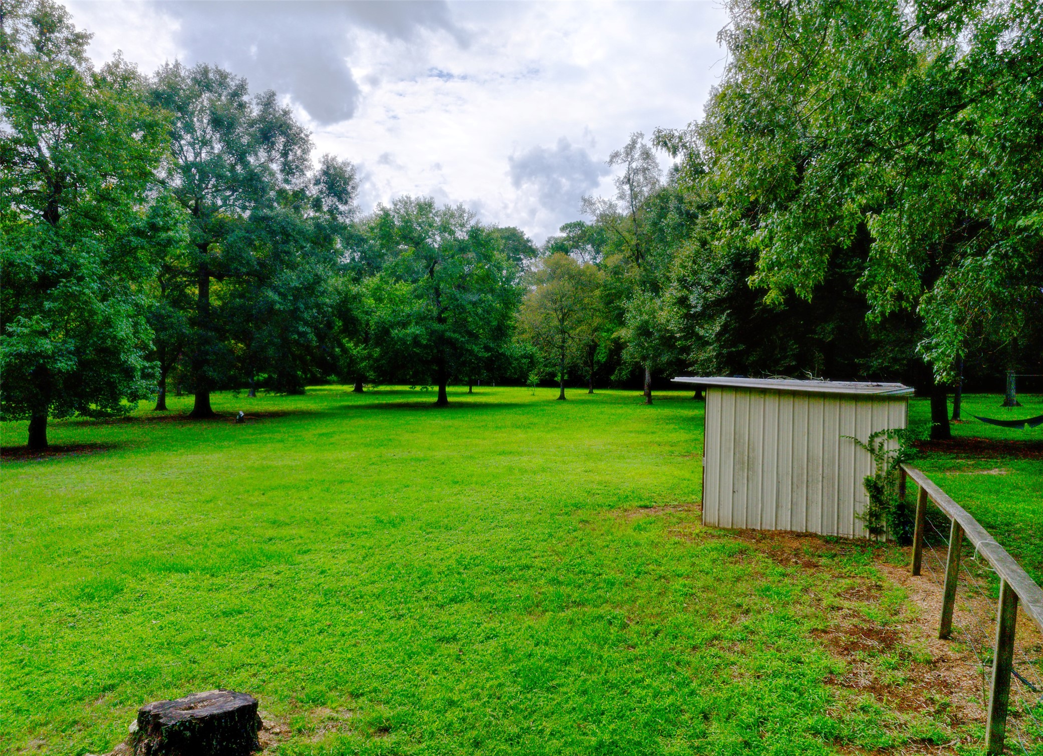 3131 Sapp Road Conroe, TX 77304 - Photo 38 of 48 a view of a backyard with a garden and entertaining space