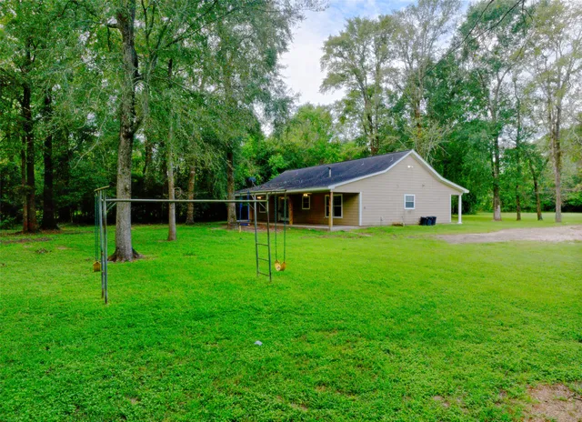 a view of a house with a backyard