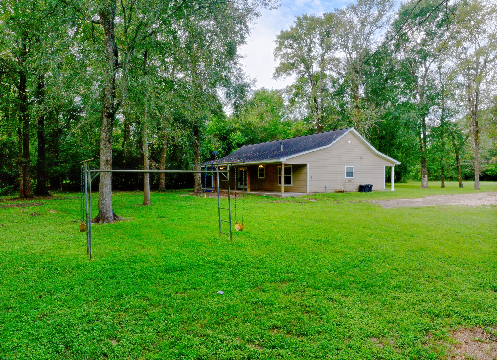 3131 Sapp Road Conroe, TX 77304 - Photo 44 of 48 a view of a house with backyard and a tree