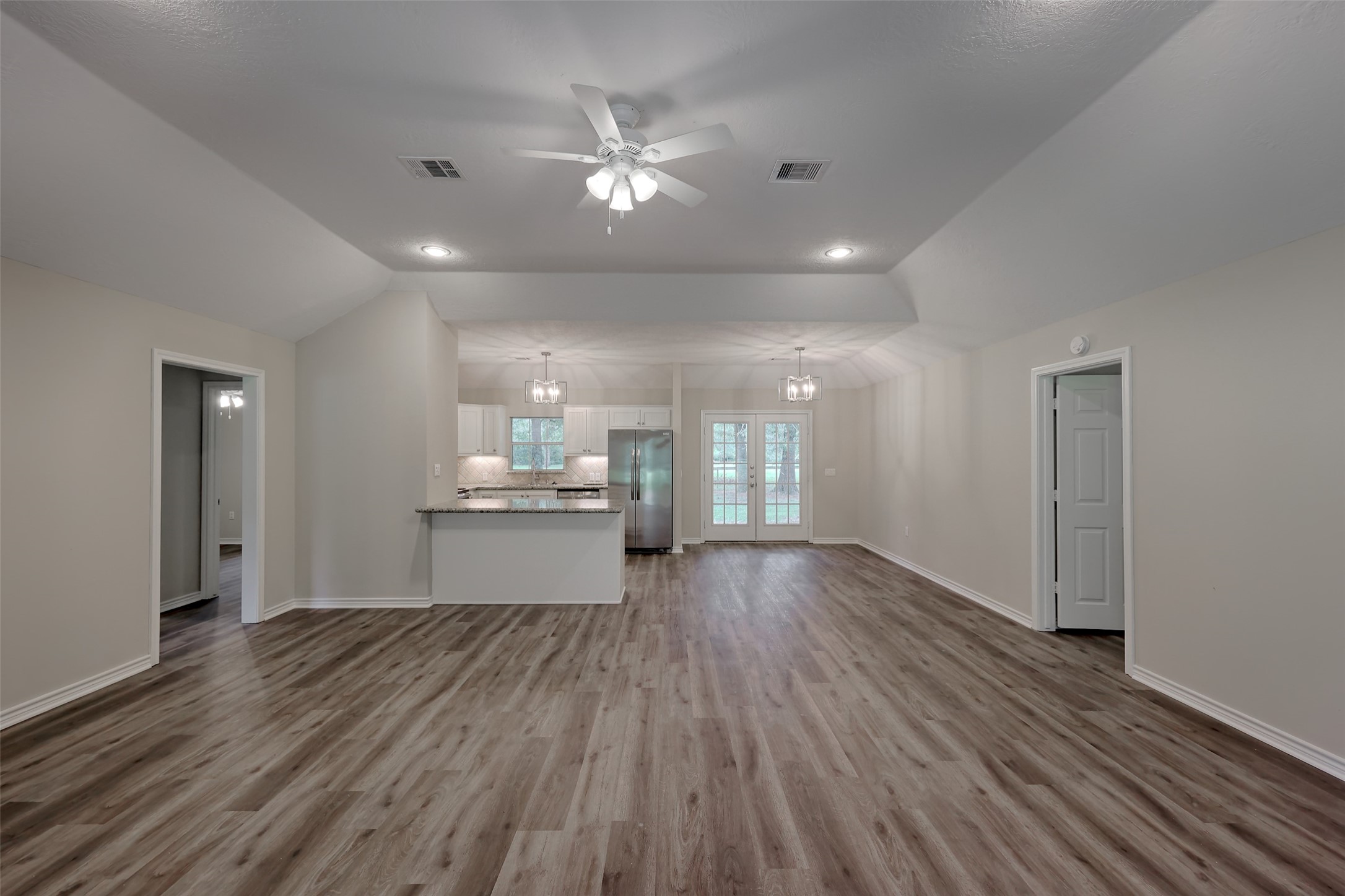 3131 Sapp Road Conroe, TX 77304 - Photo 8 of 48 a view of an empty room and kitchen with wooden floor