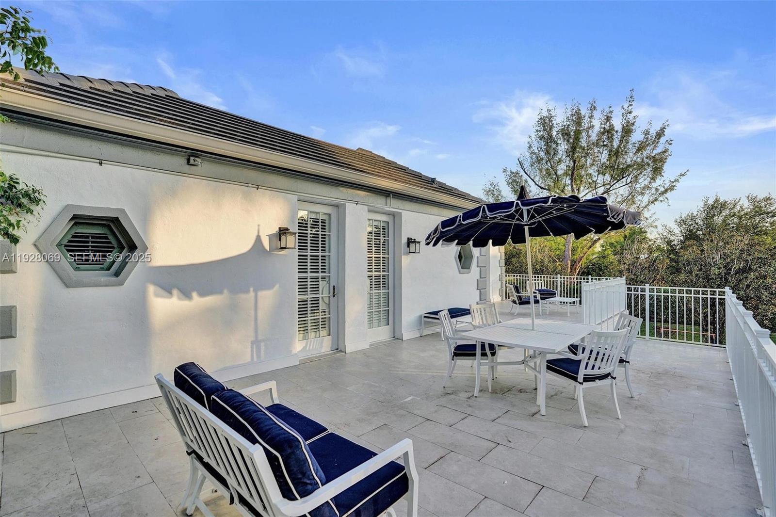 1281 Banyan Road Boca Raton, FL 33432 - Photo 60 of 69 a backyard of a house with barbeque oven table and chairs