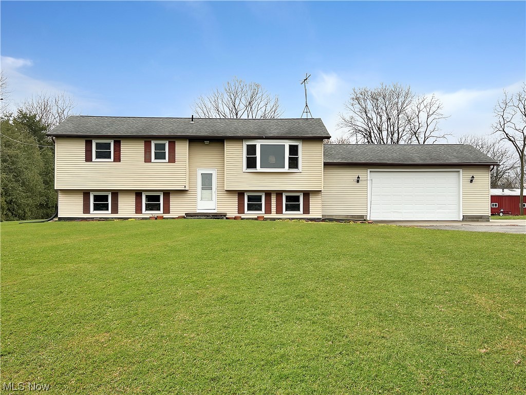 7204 Frailey Road Vermilion, OH 44089 - Photo 1 of 28 Bi-level home with a front lawn and a garage