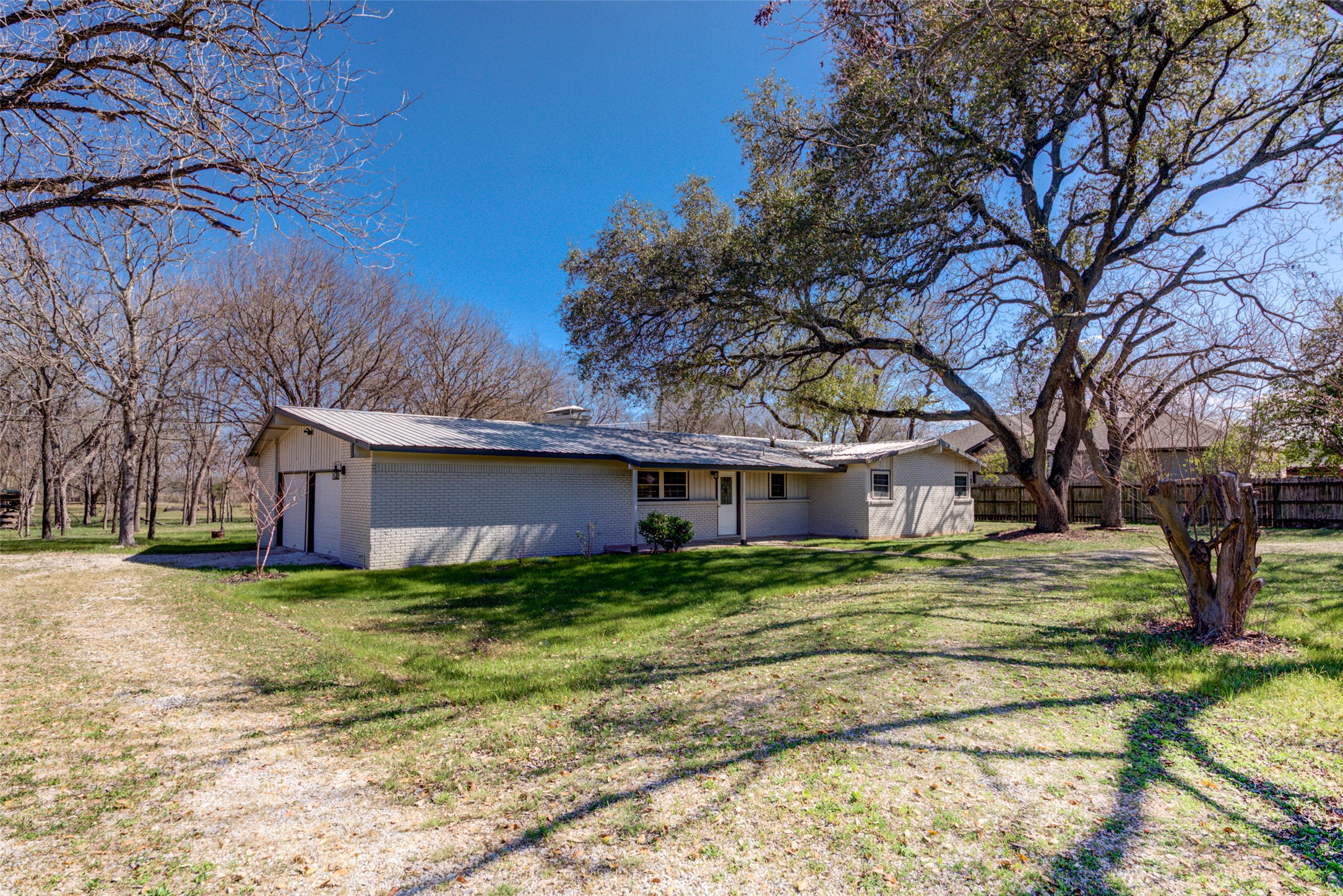 11811 Sleepy Hollow Road Manchaca, TX 78652 - Photo 1 of 35 a house that has a tree in front of it