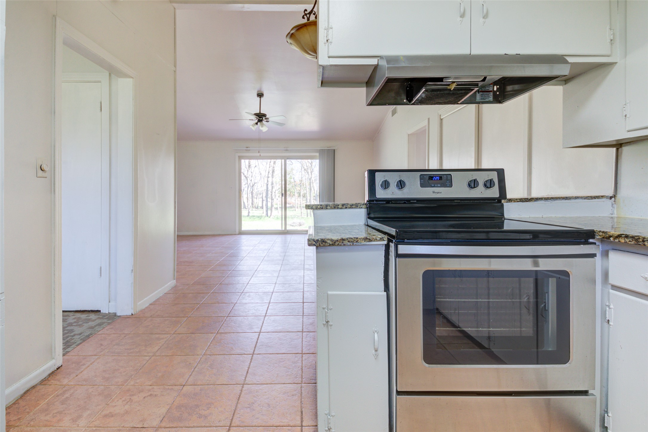 11811 Sleepy Hollow Road Manchaca, TX 78652 - Photo 13 of 35 a hallway with a stove top oven and cabinets