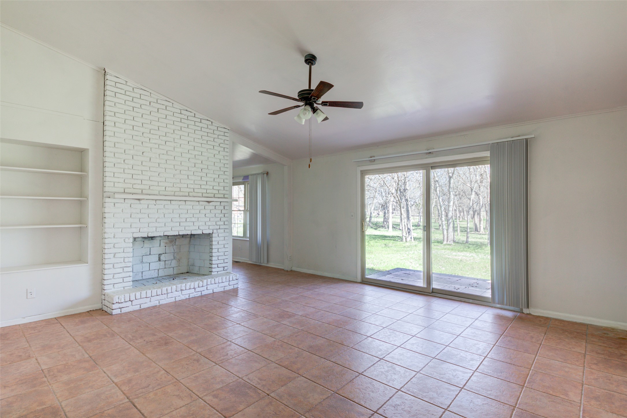 11811 Sleepy Hollow Road Manchaca, TX 78652 - Photo 14 of 35 a view of an empty room with a fireplace and a window