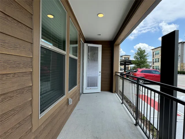 a view of a porch with wooden floor