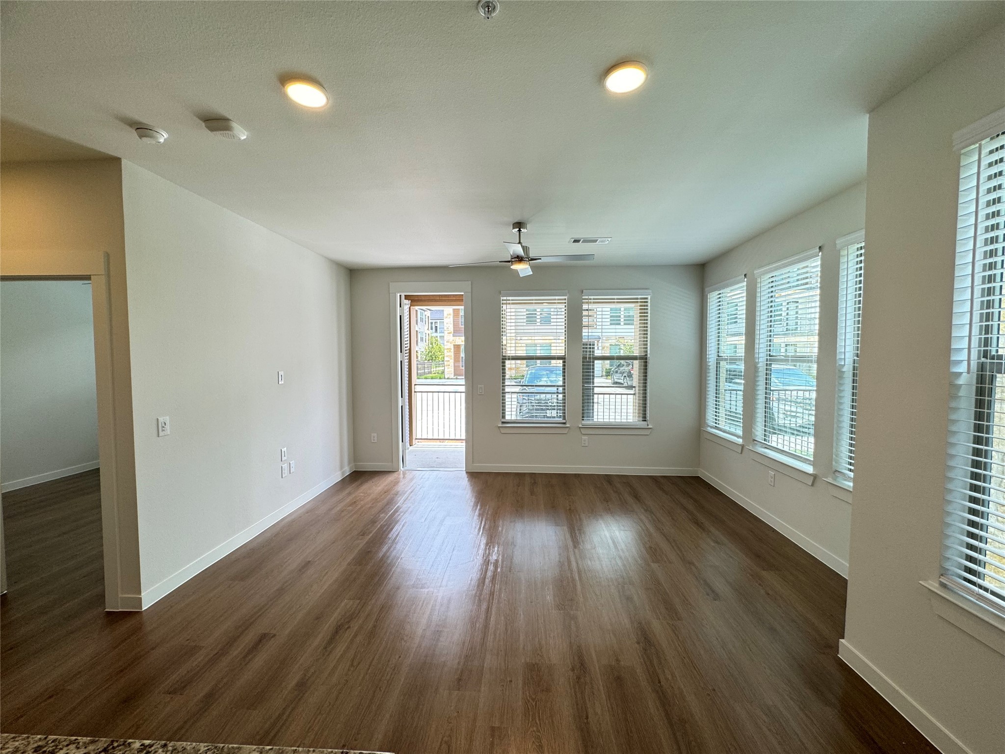9302 Fry Road, Unit A3431 Cypress, TX 77433 - Photo 6 of 11 an empty room with wooden floor and windows