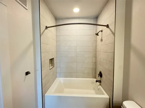 a bathroom with a bathtub and a shower