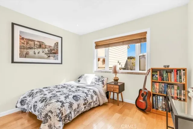 a bedroom with bed and a book shelf
