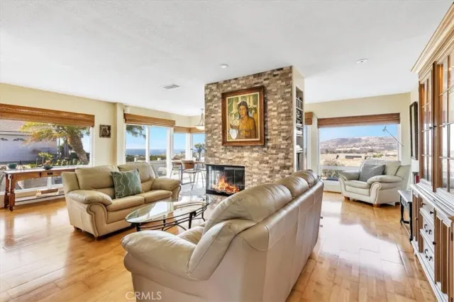 a living room with furniture large window and a fireplace
