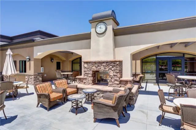 a living room with fireplace furniture and a large window