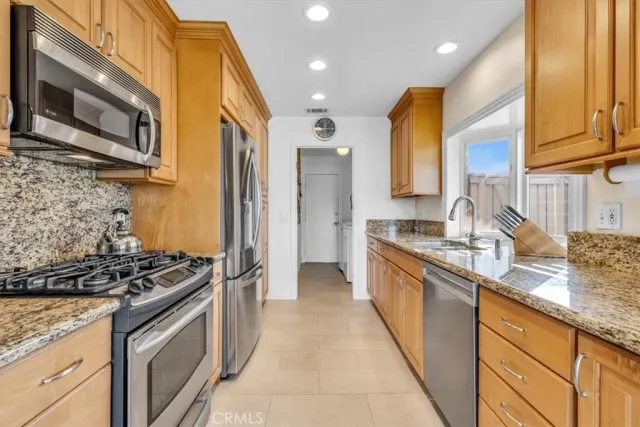 a kitchen with stainless steel appliances granite countertop a stove and a sink