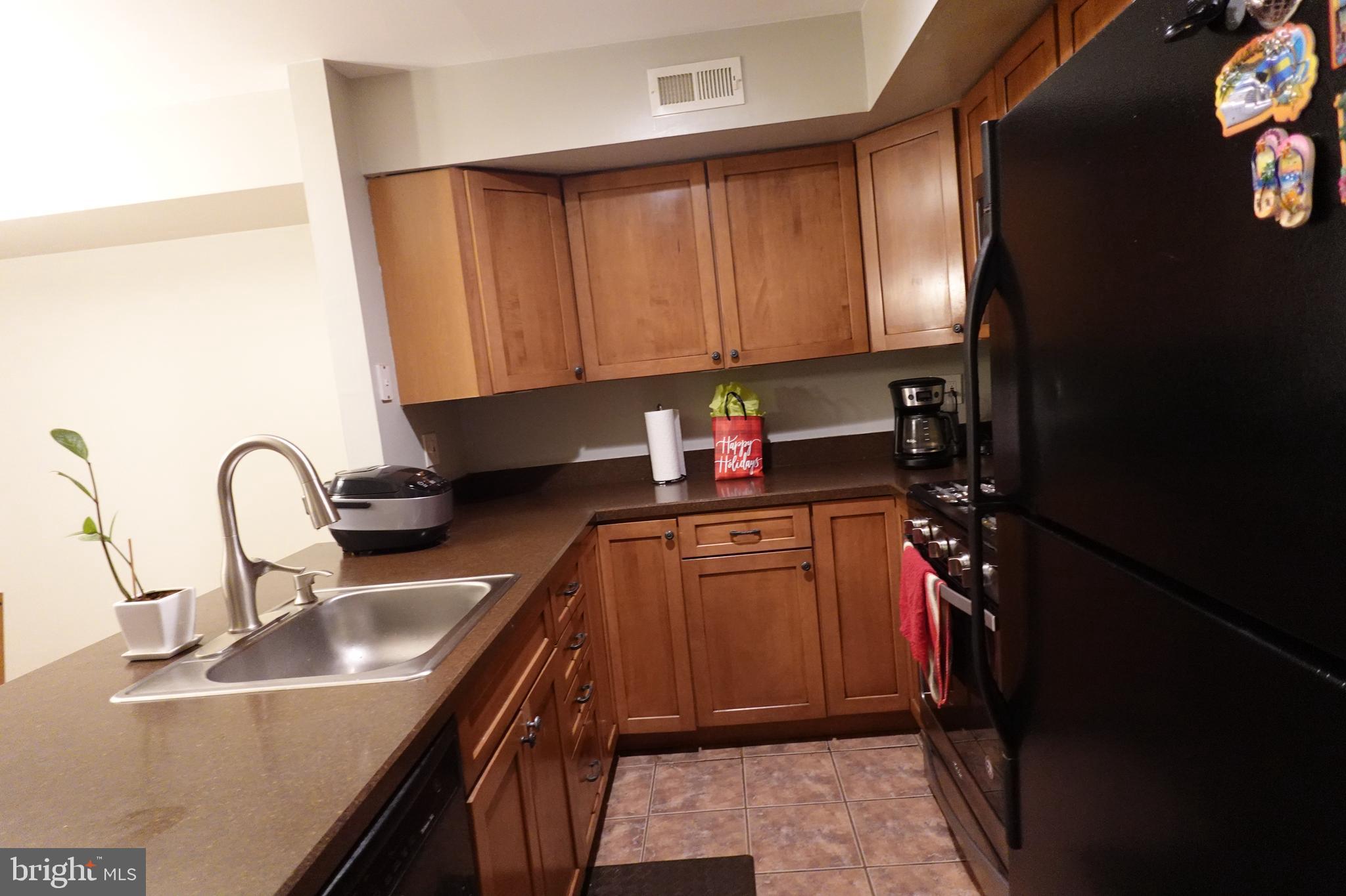 106 Five Crown Royal Marlton, NJ 08053 - Photo 6 of 27 a kitchen with granite countertop a sink stainless steel appliances and cabinets