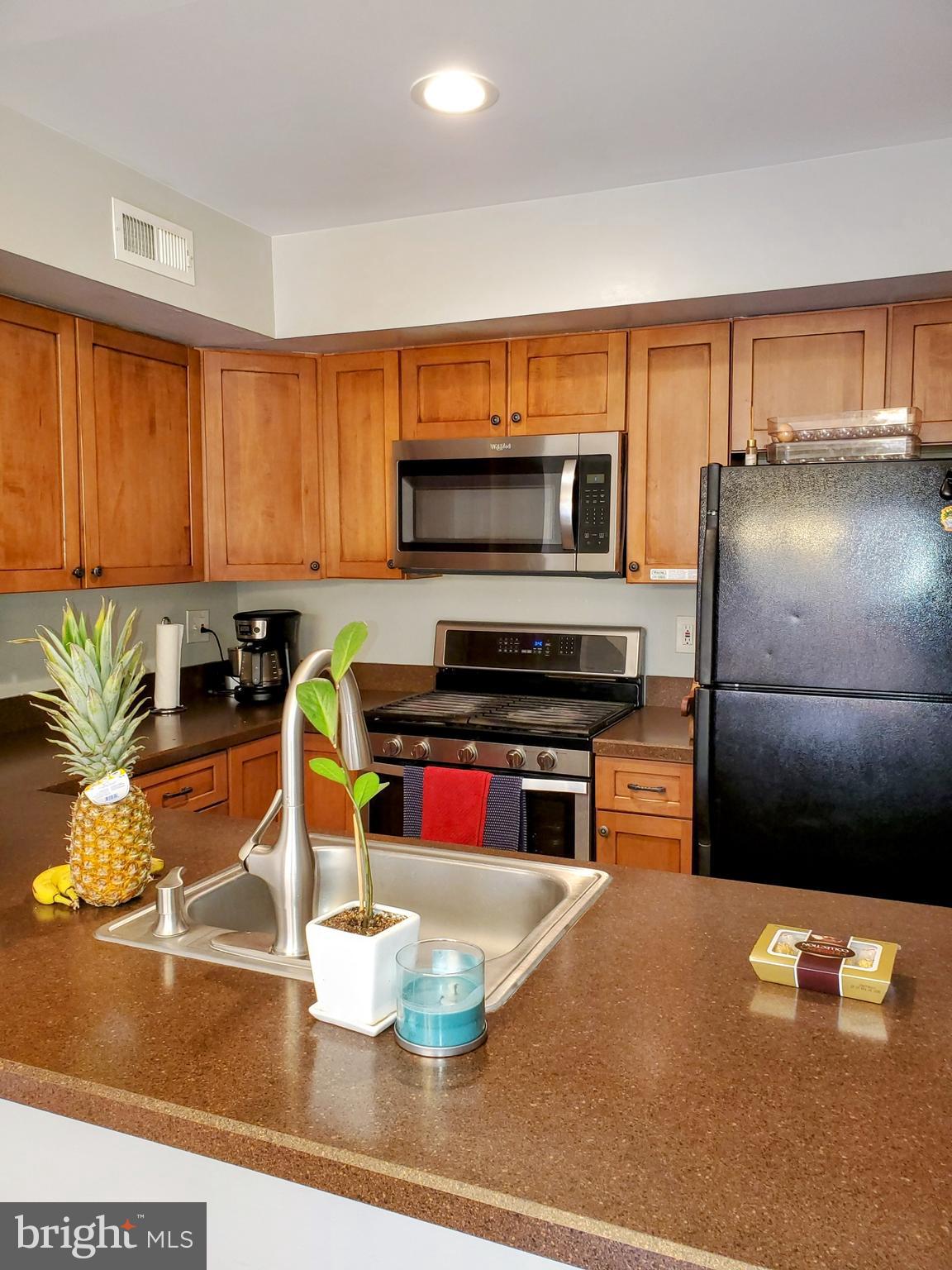 106 Five Crown Royal Marlton, NJ 08053 - Photo 8 of 27 a kitchen with stainless steel appliances granite countertop a refrigerator a stove and a sink with wooden floor