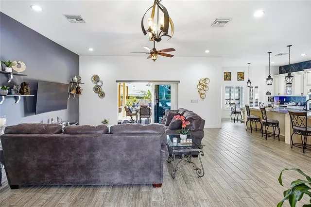 a kitchen with stainless steel appliances kitchen island granite countertop a refrigerator and microwave