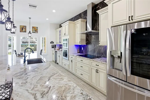 a bedroom with a bed and a flat tv screen on the dresser