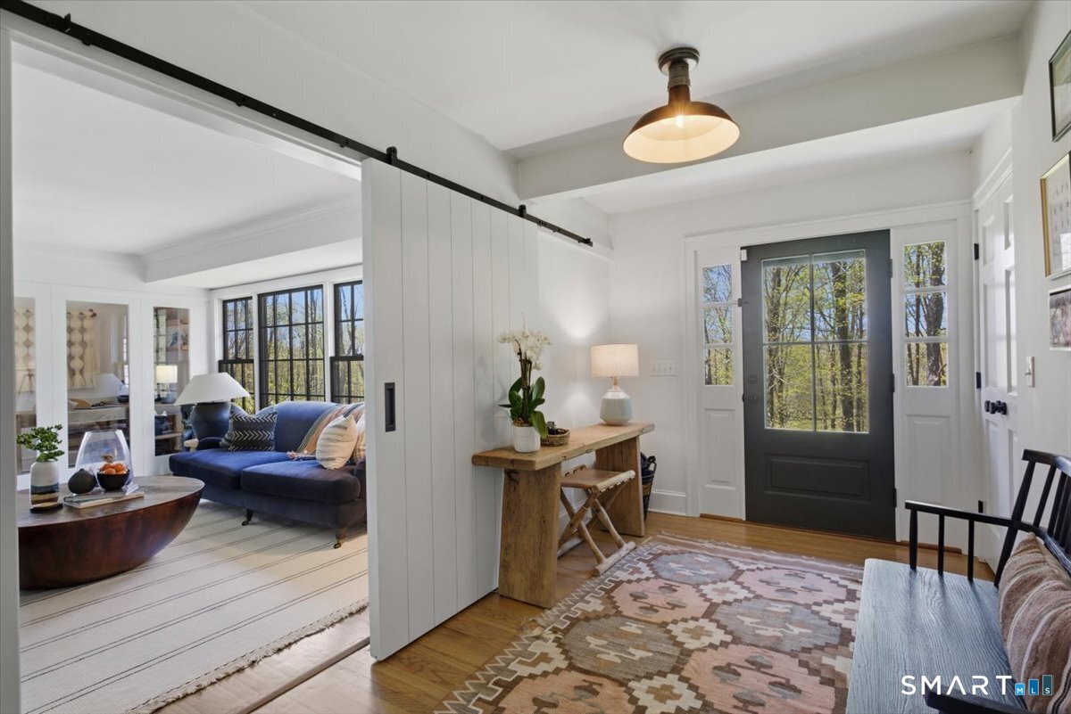 246 North Street Roxbury, CT 06783 - Photo 5 of 22 Barn door in foyer for living room privacy.