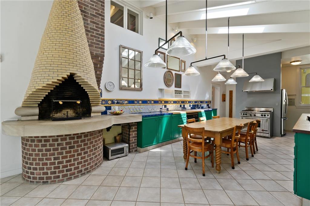 5306 Westminster Place Pittsburgh, PA 15232 - Photo 11 of 50 a kitchen with stainless steel appliances a sink a counter top space a dining table and chairs