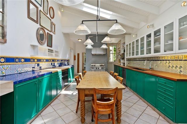 a kitchen with a table chairs and a stove