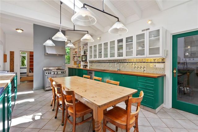 a kitchen with a table chairs and a chandelier