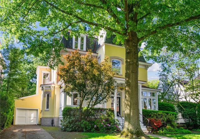 front view of a house with a tree