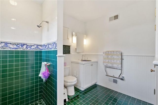 a white toilet sitting next to a bathroom sink