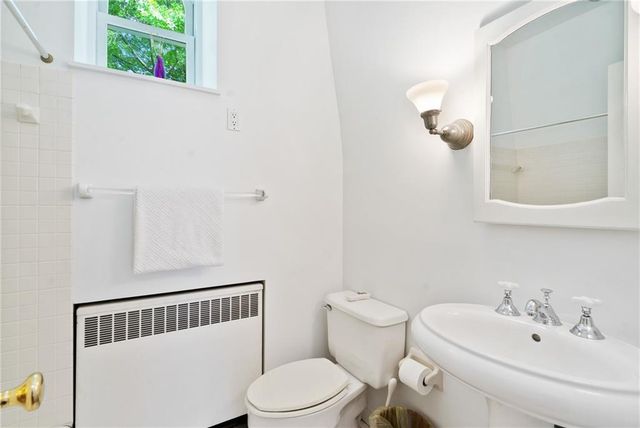a view of a hallway with a dining room and wooden floor