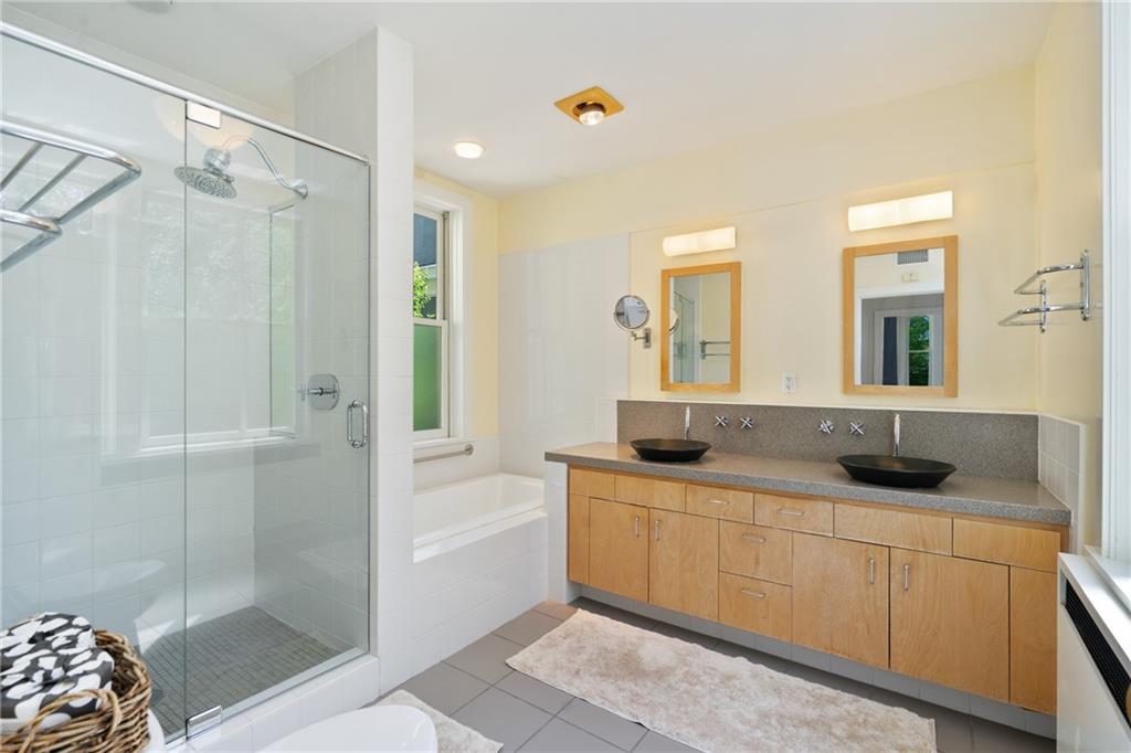 5306 Westminster Place Pittsburgh, PA 15232 - Photo 29 of 50 a bathroom with a granite countertop sink a mirror and shower