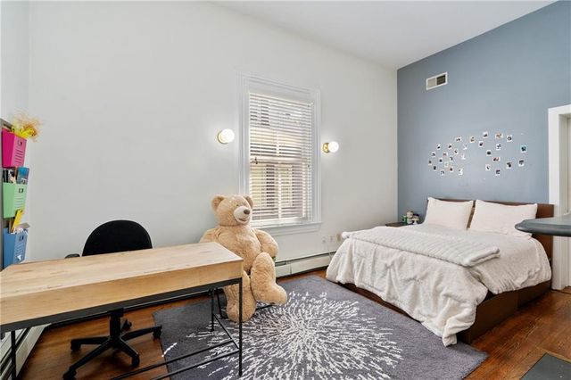 a bedroom with a bed and a dresser in it