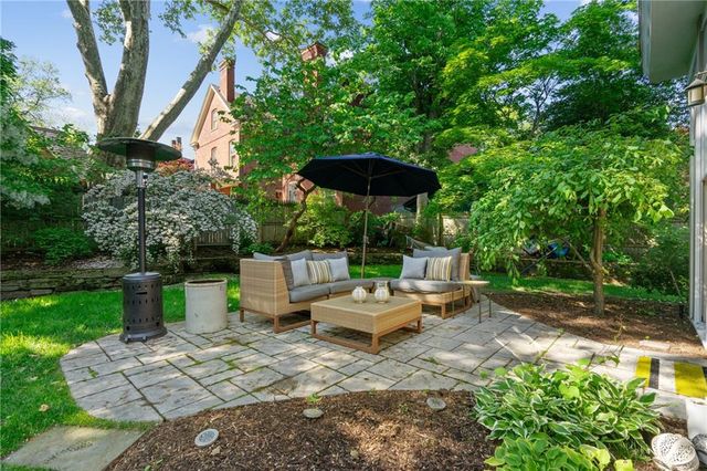 a view of a house with backyard porch and sitting area