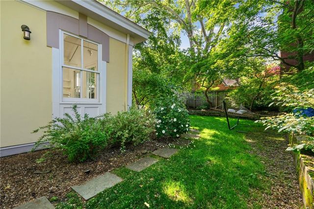 a view of a patio with table and chairs under an umbrella