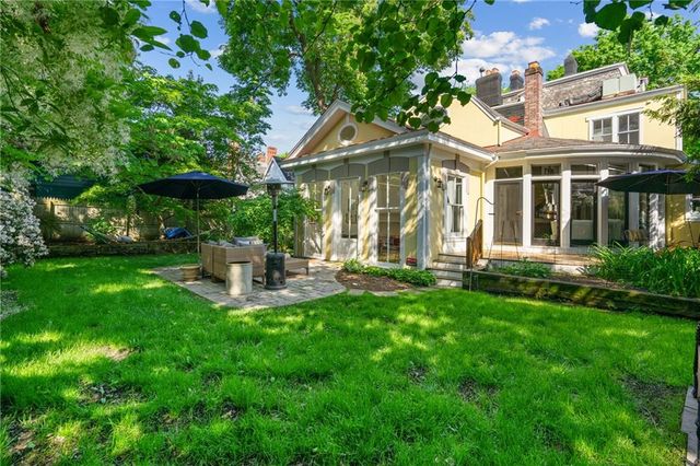 an aerial view of a house with a yard and outdoor seating