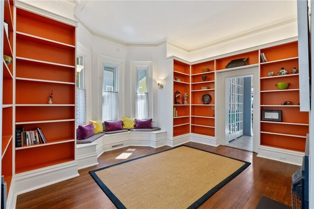 a living room with furniture and a book shelf