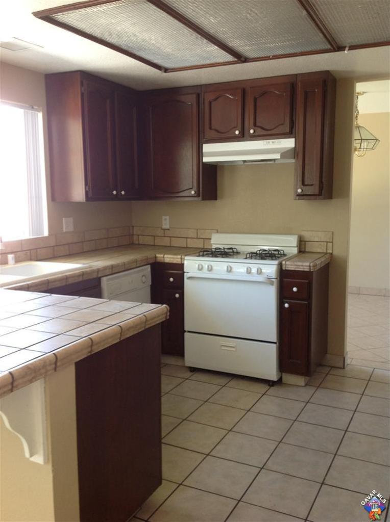44015 Sorrell Lane Lancaster, CA 93535 - Photo 5 of 5 a kitchen with stainless steel appliances granite countertop a stove a sink and a microwave