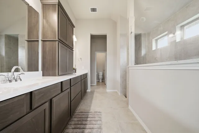 a bathroom with a double vanity sink and mirror