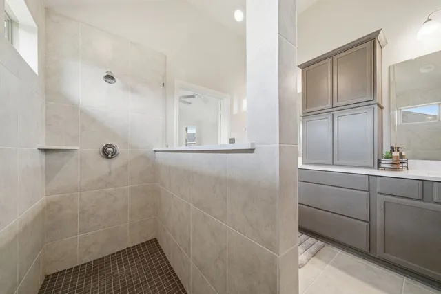 a bathroom with a shower and a sink