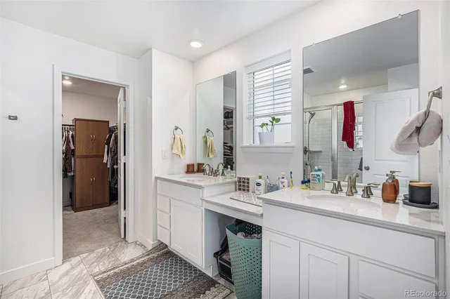 a spacious bathroom with a sink double vanity and a mirror