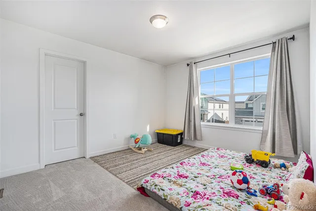 a bedroom with bed and window