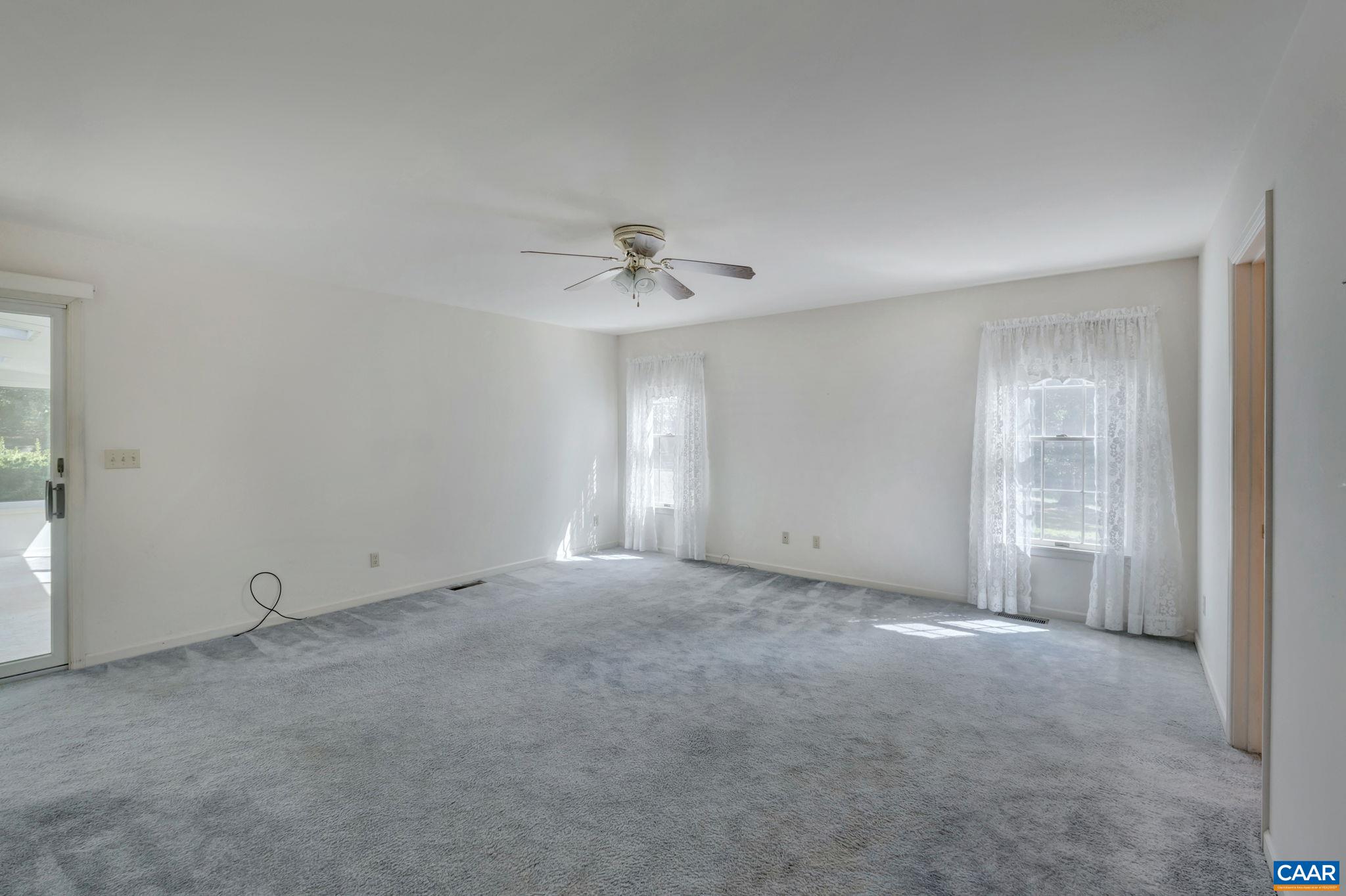 9795 Critzer Shop Road Afton, VA 22920 - Photo 16 of 22 an empty room with a ceiling fan and a window