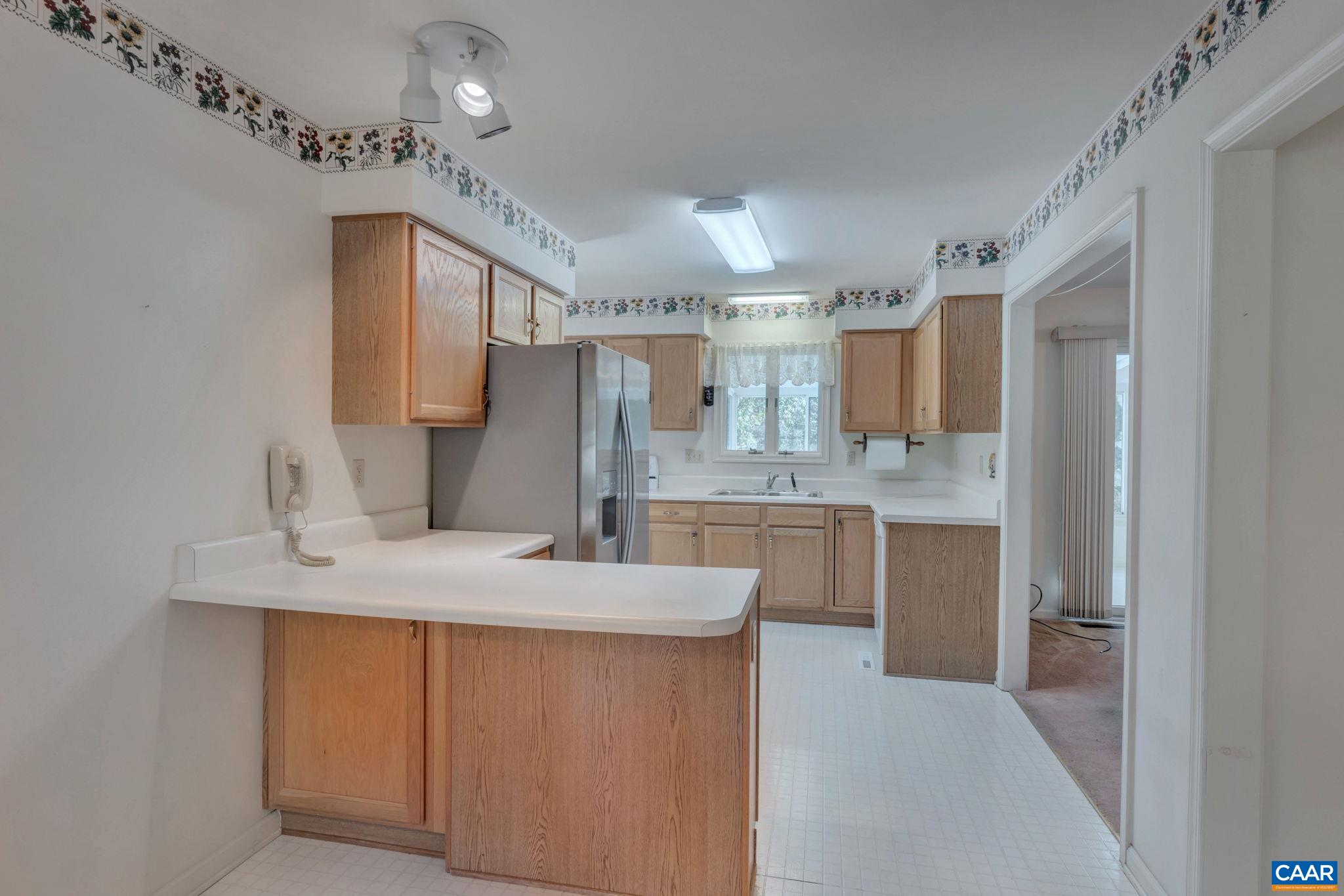 9795 Critzer Shop Road Afton, VA 22920 - Photo 8 of 22 a kitchen with kitchen island granite countertop a sink cabinets and stainless steel appliances