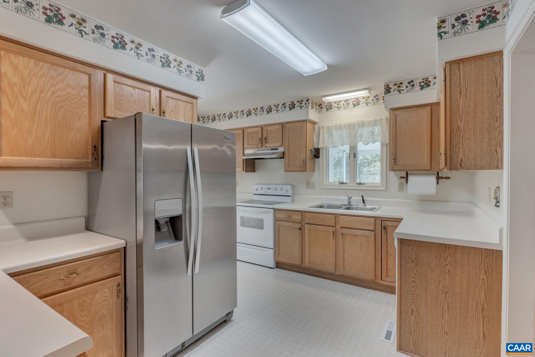 9795 Critzer Shop Road Afton, VA 22920 - Photo 9 of 22 a kitchen with stainless steel appliances granite countertop a refrigerator and a sink