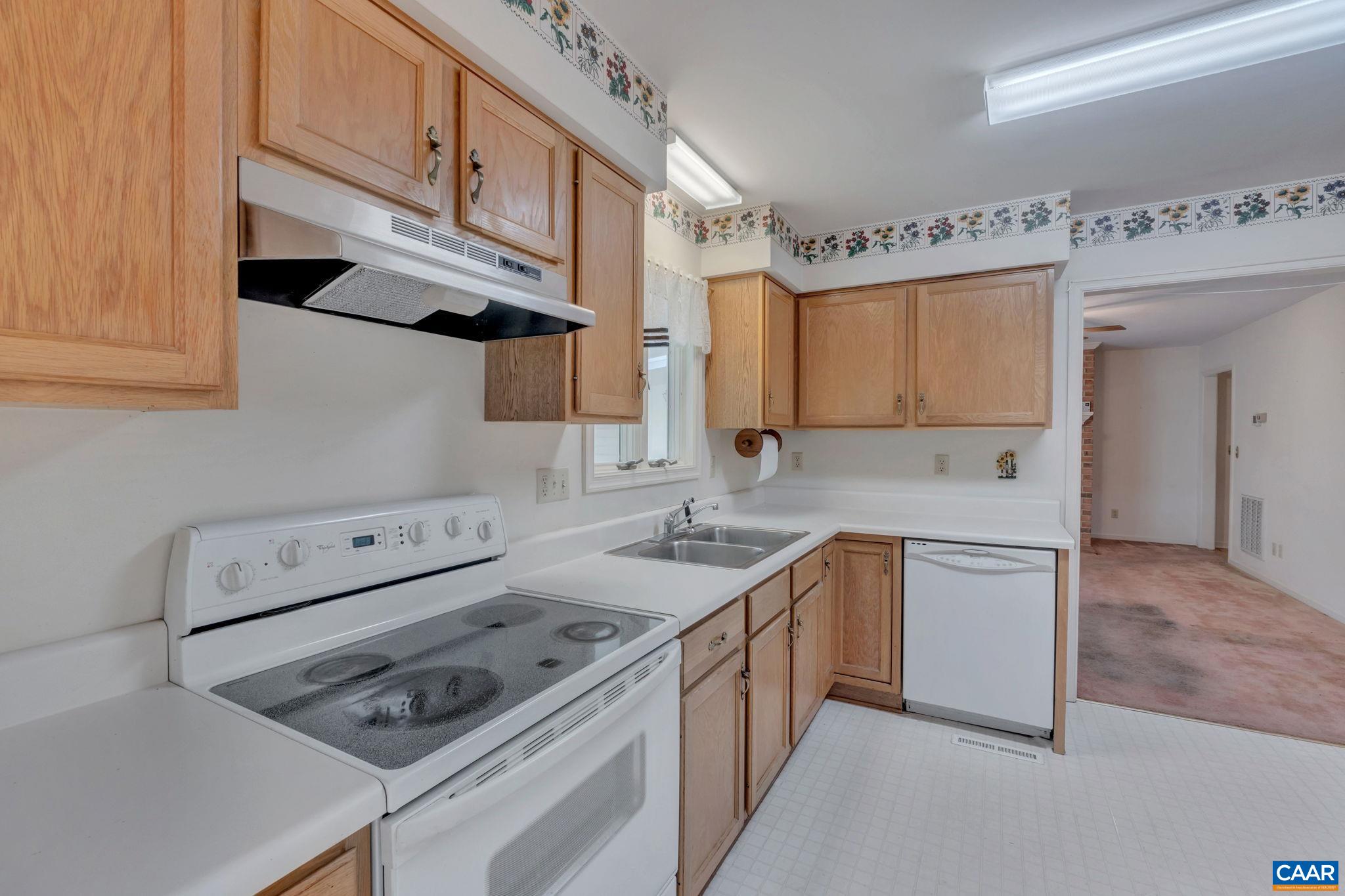 9795 Critzer Shop Road Afton, VA 22920 - Photo 10 of 22 a kitchen with stainless steel appliances granite countertop a sink stove and cabinets