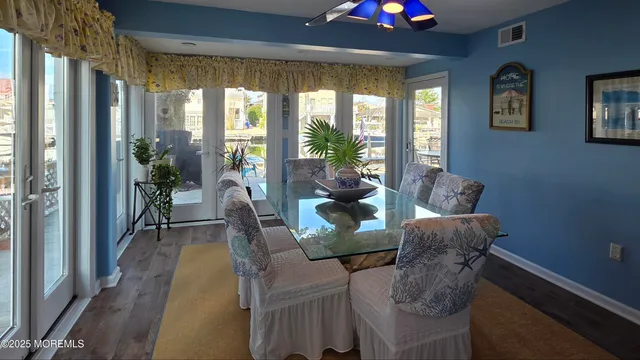 a dining room with furniture and wooden floor