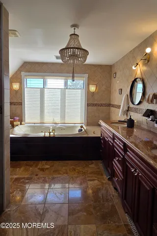 a room with granite countertop a sink and a wooden floor